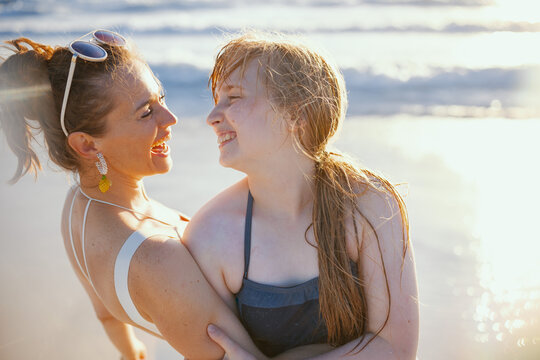 Happy Mother And Teenage Daughter At Beach Having Fun Time