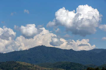 Clouds in dramatic formation over the chain of hills, with blue sky on countryside of Brazil. Space...