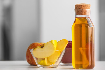 Bottle of fresh apple juice on table