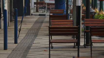 Fototapeta na wymiar chair on the city sidewalk