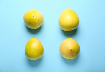 Composition with ripe pomelo fruits on blue background