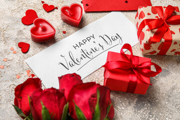 Card with text HAPPY VALENTINE'S DAY, gifts, roses and candles on grunge background, closeup