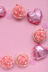 Frame made of balloons and tasty cupcakes for Valentine's Day on pink background