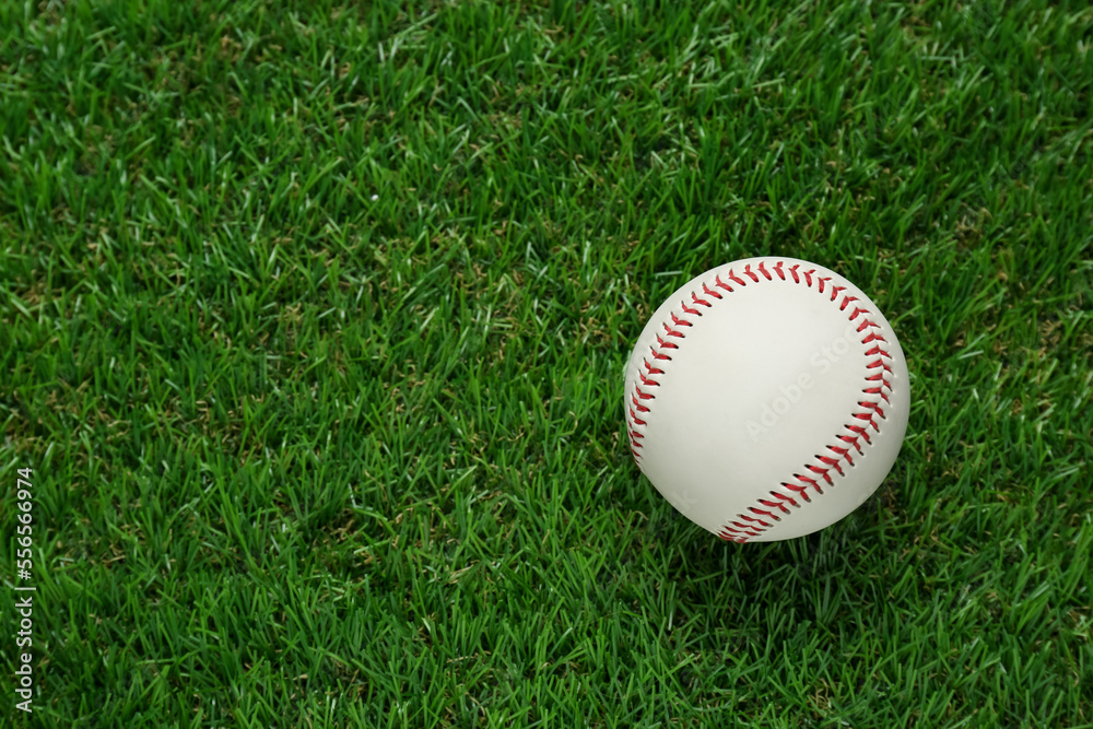 Poster Baseball ball on green grass, top view with space for text. Sports game