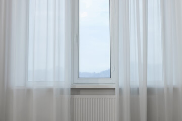 Fototapeta na wymiar Window with elegant white curtains indoors. Interior design