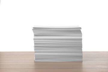Stack of paper sheets on wooden table against white background