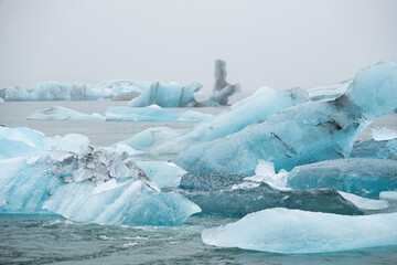 Iceland Lake with Melting Glaciers in Foggy Weather, Pure Blue Ice in Jokulsarlon lagoon.