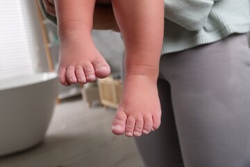 Mother with her daughter after bath, closeup. Focus on child`s feet