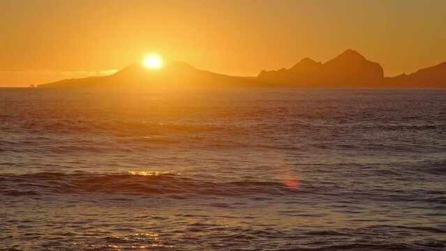Sunrise over Stormy Sea, Shining Golden Waves with Sun Reflection at Sunset, Amazing light over Icelandic Nature, Shot in 8K Resolution 4320p