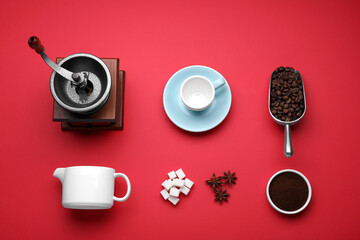 Obraz na płótnie Canvas Flat lay composition with vintage manual coffee grinder and beans on red background