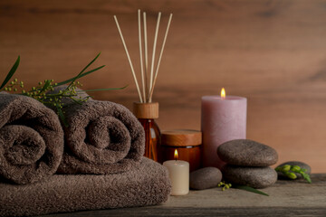 Obraz na płótnie Canvas Beautiful spa composition with different care products and burning candles on wooden table