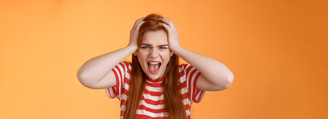 Pissed fed up redhead female teenager annoyed, break down, grab head yelling hateful displeased,...