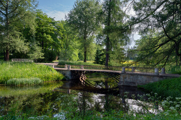 The bridge over the Upper Ponds to the kitchen ruins in Catherine Park of Tsarskoye Selo on a sunny...