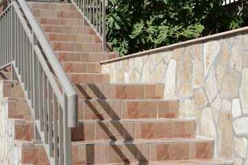 Beautiful tiled stairs with metal railings outdoors