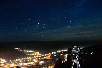 Picturesque view of city and modern telescope in night outdoors. Learning astronomy