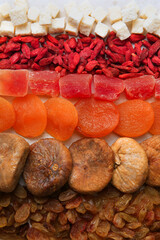Different tasty dried fruits as background, top view