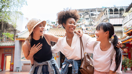 Young happy multi ethnicity tourists sightseeing in city. Diversity people African, Asian, Caucasian friends travel holiday together in China town. © Chalermphon