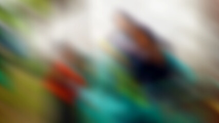 Abstract blurred background with a composition of green, white, blue, and a little red and black.