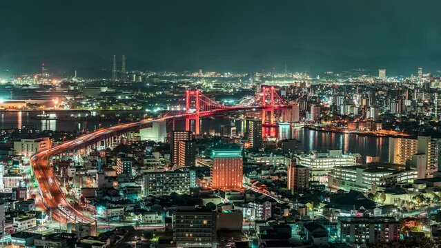 Night Time lapse of Kitakyushu City with Wakato Bridge from Takatoyama Observatory. Fukuoka Japan. Landmark in Business downtown in Kitakyushu Fukuoka Japan. Public transport Business District