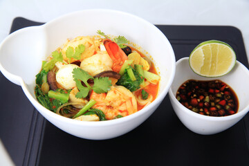 curry food, Chinese, indian and asian food, shrimp mixed with quail egg and vegetables with hot curry souce in white bowl,