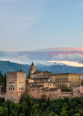 Fototapeta premium Aerial view of the Alhambra Palace in Granada, Spain with snow-capped Sierra Nevada mountains in the background.