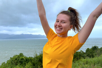 Happy young beautiful carefree woman traveler is hiking, travelling, enjoying freedom, walking on...