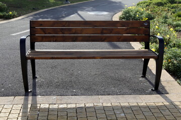 Bench for rest in the city park on the seashore.