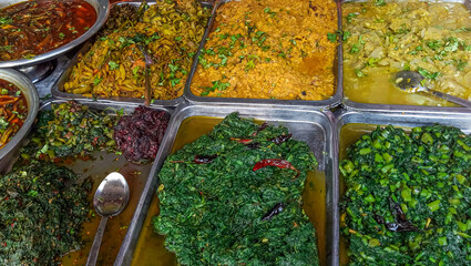 Bangladeshi variety of cooked curries. A variety of curries hot food on display.