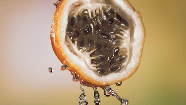 Slow Motion Macro Shot of Flowing Granadilla Juice from Halved Granadilla