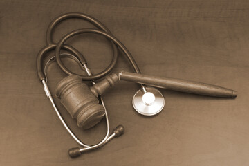 Broken judge gavel and stethoscope, criminal medicine concept.