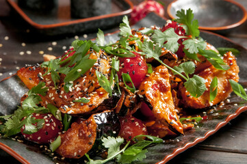 Oriental style vegetable salad with eggplant, soy sauce and chopsticks on a wooden table. Rustic style.