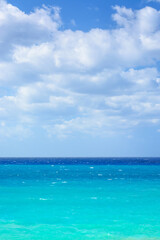 Fototapeta na wymiar View of the sea in blue tones in cloudy weather