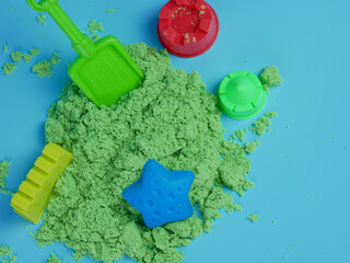 set of green sand toys and prints isolated on blue background