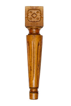 Carved wooden leg from the furniture on a white background.