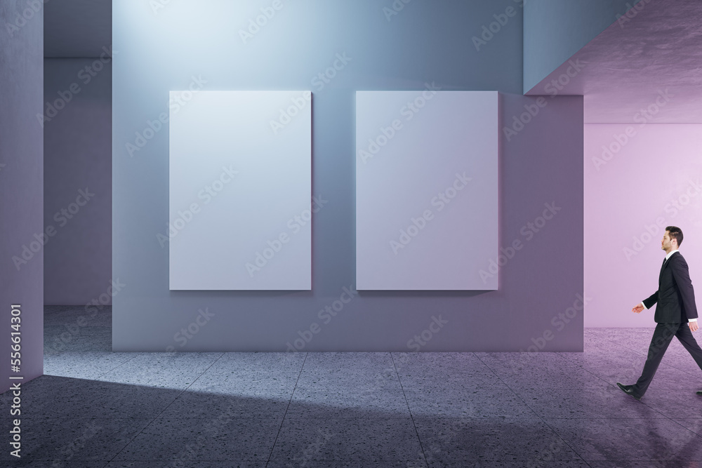 Aufkleber side view of businessman walking in modern concrete gallery interior with mock up banners on wall an