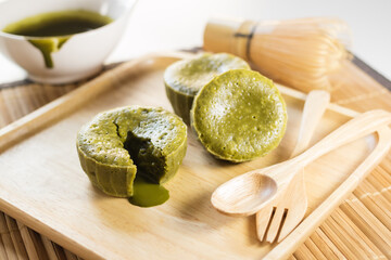 Green tea (Matcha) lava cakes on wooden plate.