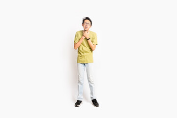 Fototapeta premium A single skinny young male has a sore throat. The full body of an Asian or Indonesian person. Isolated photo studio with white background.