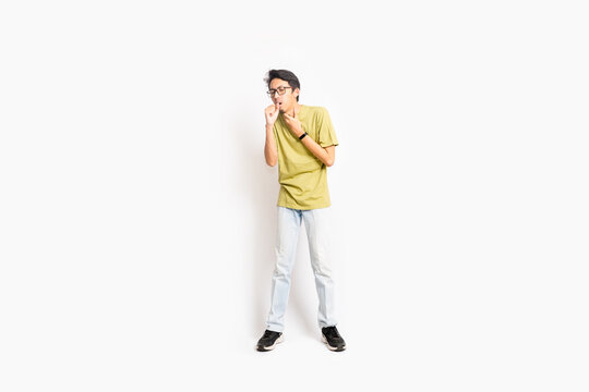 A single skinny young male has a sore throat. The full body of an Asian or Indonesian person. Isolated photo studio with white background.