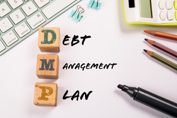 DMP - Debt Management Plan. Wooden blocks on a white office table