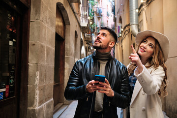 Couple visiting a city and using a mobile phone