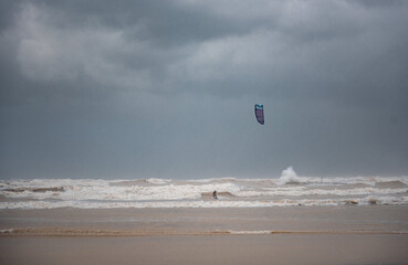 Stormy Mediterranean Sea and Cloudy Sky in Tel Aviv, Israel. Man with Power Kite