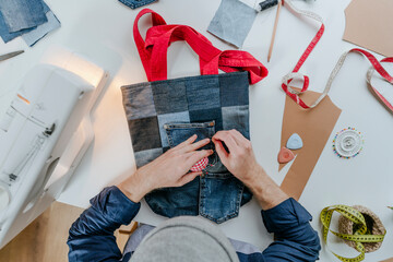 Fashion designer stitching pocket on shopping bag