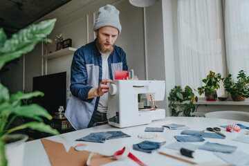 Fashion designer adjusting sewing machine in workshop