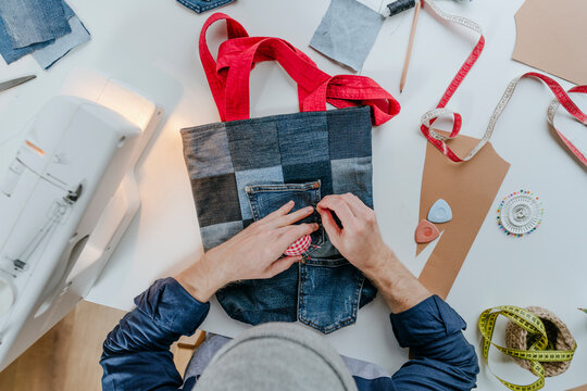 Fashion designer stitching pocket on shopping bag