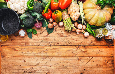 Food background with vegan cooking ingredients. Organic vegetables, pumpkin, mushrooms, asparagus,...