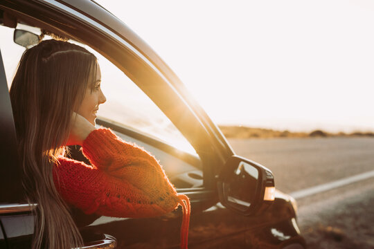 Woman In Car Looking At Road Ahead Of Her