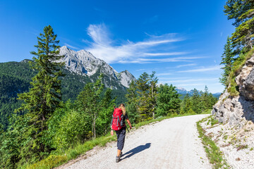 Germany, Bavaria, Female hiker following trail in Wetterstein mountains