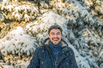 Happy man enjoying in winter park