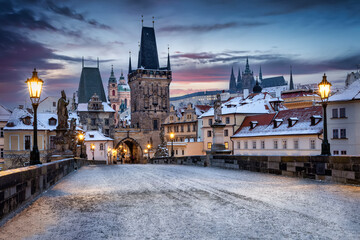 View from the historic Charles Bridge in Prague, Czech Republic, to the snow covered rooftops of the old town during a cold winter morning