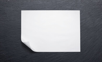 Butcher paper with a folded corner against a slate board